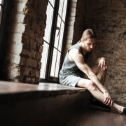 Portrait of a fitness man suffering from a leg pain