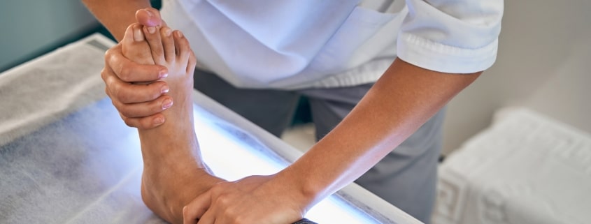 Close up of medical worker massaging foot
