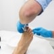 Nurse is taking care of patient after nail operation