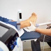 Shock wave therapy of the heel spur. Physiotherapist doctor uses medical equipment for highly effective heel pain treat. Concept of medical orthopedic treatment. The magnetic field, rehabilitation